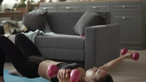 Woman Doing Chest Flys with Dumbbells at Home