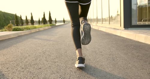 Woman Running Outdoors in Golden Hour Light