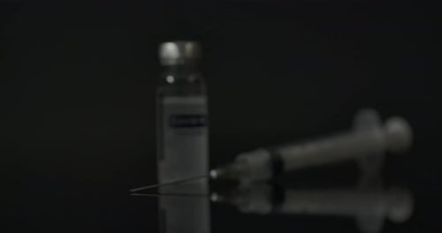 COVID-19 Vaccine Vial and Syringe Focus Pull