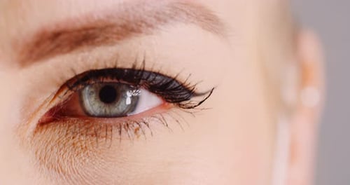 Macro Shot of Blue Eye Opening Human Iris. Womans Eye