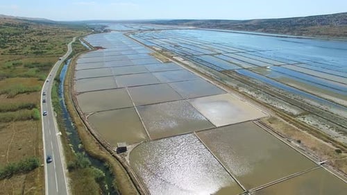 Aerial view of cars passing salt fields, Pag island, Croatia