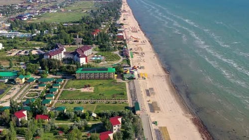 Beautiful flight in summer over the beach. People are resting near the sea.