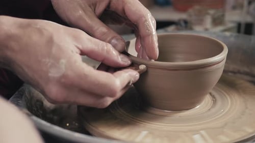 Craftsman Shaping Clay Bowl on Pottery Wheel