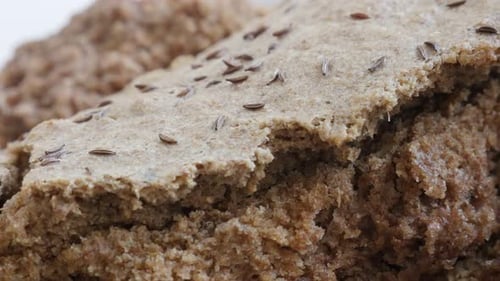 Close-Up of Textured Brown Bread with Scattered Seeds