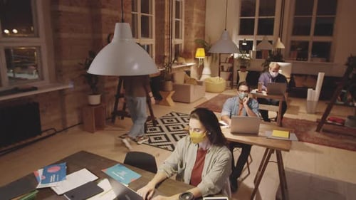 Business People in Face Masks Working Late in Loft Office