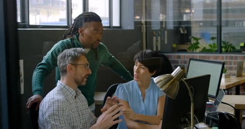 Business people discussing over computer in office 4k
