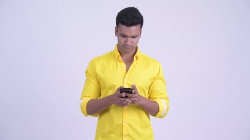 Man In Yellow Shirt Uses Mobile Phone