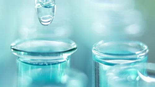 Liquid Being Dripped into Test Tube Close Up