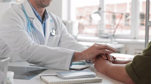 Caring Doctor Comforts Patient in Clinic