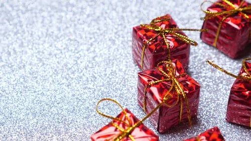 Red Gift Boxes with Gold Bows on Silver Background