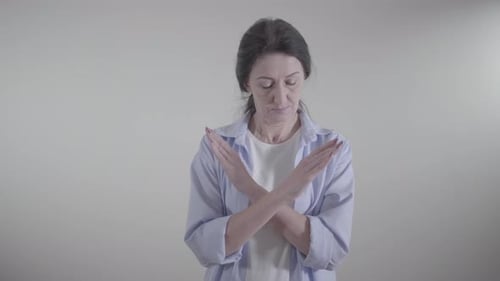 Portrait of Serious Caucasian Woman Crossing Hands and Gesturing No By Shaking Head. Rejection