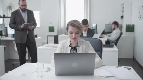 Women and Men Collegues Sit at a Table and Work