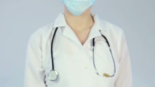 Doctor Gesturing Stop with Protective Medical Gear