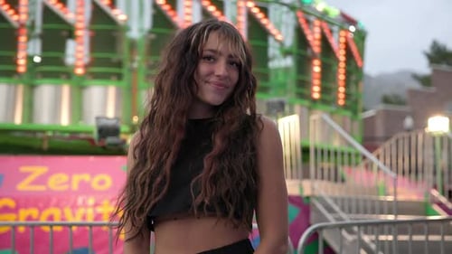 Smiling Woman at Urban Amusement Park