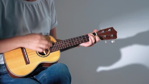 Close-up of Female Hands Playing on Ukulele