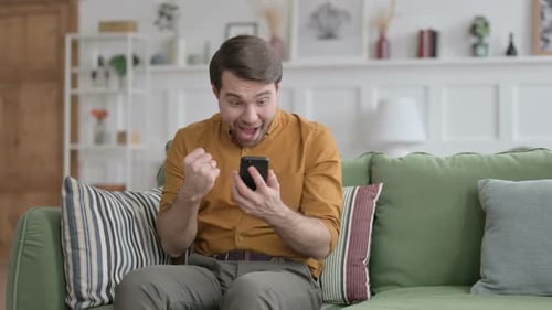 Man Reacts to Good News on His Phone