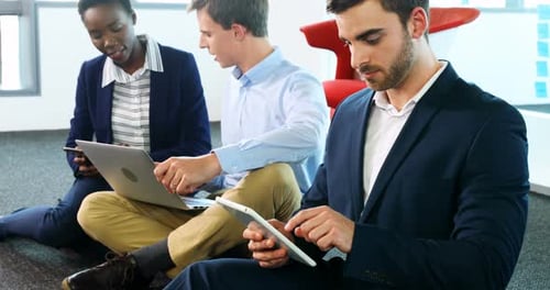 Young Adults Working With Technology in Modern Office