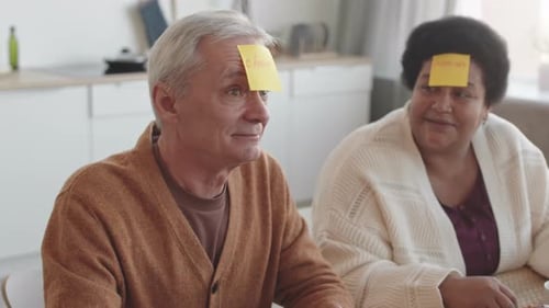 Friends Playing Game at Table with Sticky Notes