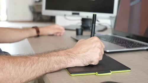 Man Using Graphic Tablet and Pen for Design