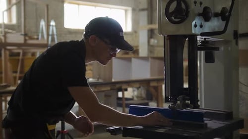 Carpentry Workshop Worker Cutting Wooden Details with an Automatic Saw
