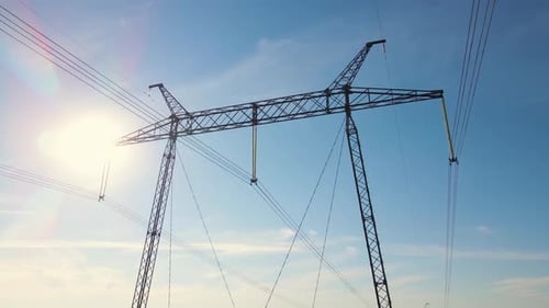 Electrical Tower Metallic Silhouette Against Bright Blue Sky