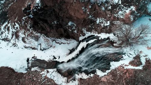 Aerial View of Snowy Waterfall in Winter