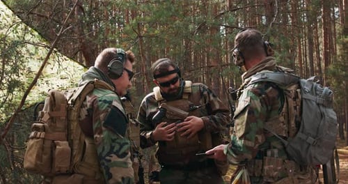 Tactical Military Team Discusses Strategy in Forest