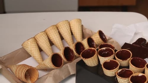 Waffle Cones and Cups Filled With Chocolate