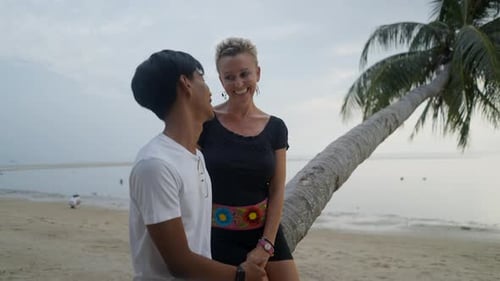 Happy Interracial Couple Dating on a Beach