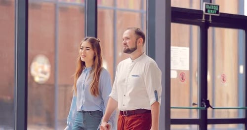 Man and a Girl Enter the Mall