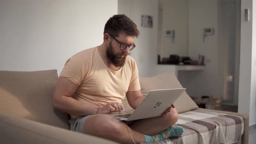 Freelancer Works at Home on a Laptop.