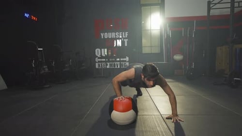 Portrait of middle east man using a training ball. Muscle strength training workout at gym fitness