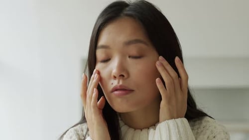 Woman Applying Gentle Pressure to Face