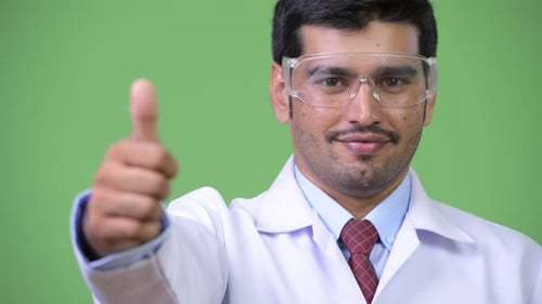 Man in Lab Coat Gives Thumbs Up
