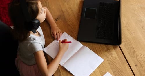 Girl Studying Online with Laptop at Home
