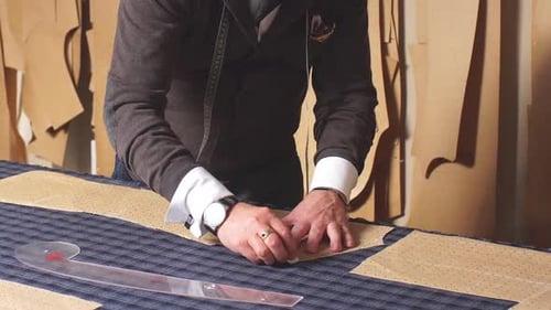 Qualified Creative Designer Male Working in Showroom Making Patterns for Sewing on Textile Materials