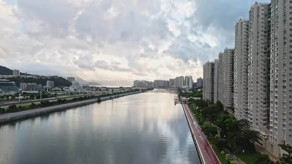 Aerial riser over Shing Mun river reveals modern Shatin neighbourhood ...