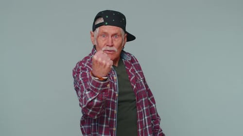Older Man Threatening with Fist