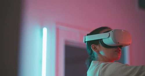 Woman Wearing VR Headset with Neon Lighting