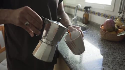 Person Pouring Coffee in Kitchen During the Daytime