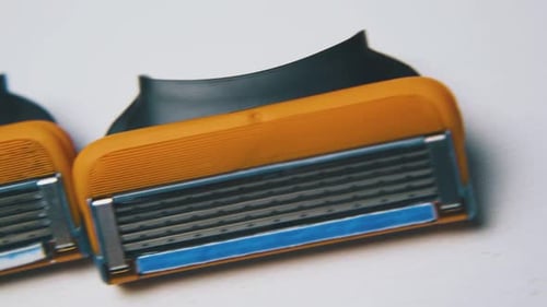 Close Up of Disposable Razors on White Surface