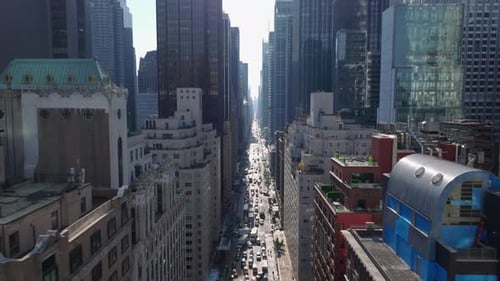 Forwards Fly Above Busy Avenue Between Modern High Rise Office Downtown Buildings