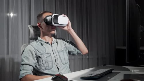 Adult Using Virtual Reality Headset at Computer