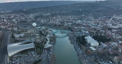 Aerial view of Tbilisi city central park and Bridge of Peace. Beautiful cityscape of old Tbilisi
