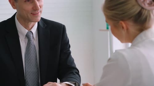 Business Meeting with Man and Woman in Workplace