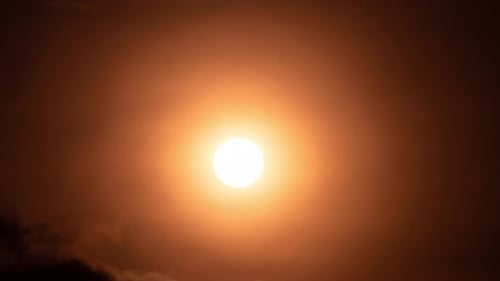 Golden Sun Rising Behind Dark Clouds