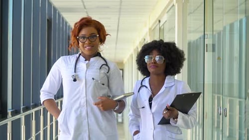 Close Up of Two African American Doctors in Hospital Looking at the Camera