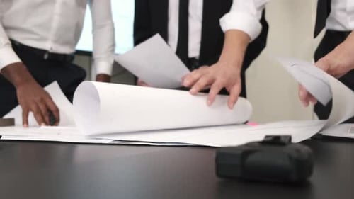 Team Reviews Architectural Plans in Office