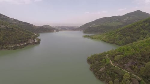 Scenic Lake Surrounded by Green Lush Hills