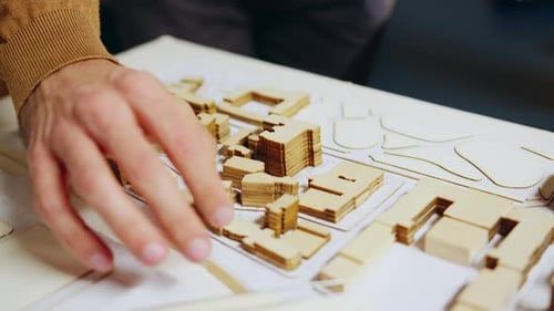 Close Up of Architect Hand Checking City Model Concept